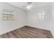 Simple bedroom featuring wood-look floors and large windows at 10206 Lola St, Tampa, FL 33612