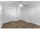 Bright bedroom with wood-look floors and double closets at 10206 Lola St, Tampa, FL 33612