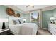 Bedroom with green walls, double bed and window at 10615 Sun Drop St, Venice, FL 34293