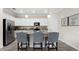 Modern kitchen with white cabinets and granite island at 10615 Sun Drop St, Venice, FL 34293