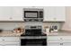 Stainless steel range and microwave in modern kitchen at 10615 Sun Drop St, Venice, FL 34293