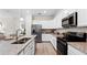 Modern kitchen with stainless steel appliances and granite countertops at 10615 Sun Drop St, Venice, FL 34293