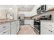 Modern kitchen with stainless steel appliances and granite countertops at 10615 Sun Drop St, Venice, FL 34293