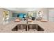 Kitchen island with double sink overlooking living room at 10615 Sun Drop St, Venice, FL 34293