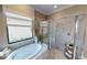 Bathroom with soaking tub and walk-in shower at 10741 Buttercup Ct, Venice, FL 34293