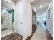 Clean hallway with wood-look floors and view into bathroom and living area at 12969 Brookside Moss Dr, Riverview, FL 33579