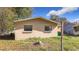 Tan block house exterior with two windows at 15572 George Blvd, Clearwater, FL 33760