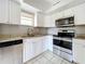 Updated kitchen featuring white cabinets and granite countertops at 15572 George Blvd, Clearwater, FL 33760