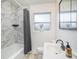 Clean bathroom with marble tile, bathtub, and modern vanity at 1601 Lakeview Rd, Clearwater, FL 33756