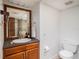 Bathroom with wood vanity, toilet and a large mirror at 1601 Lakeview Rd, Clearwater, FL 33756
