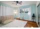 Bedroom with crib, rug, and plenty of natural light at 1601 Lakeview Rd, Clearwater, FL 33756