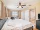 Main bedroom with king-size bed, ceiling fan and wood floors at 1601 Lakeview Rd, Clearwater, FL 33756