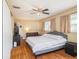 Main bedroom with king bed, ceiling fan, and access to bathroom at 1601 Lakeview Rd, Clearwater, FL 33756