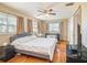 Main bedroom with king-size bed, ceiling fan and wood floors at 1601 Lakeview Rd, Clearwater, FL 33756