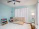 Bright Bedroom with crib, shelving, and ample natural light at 1601 Lakeview Rd, Clearwater, FL 33756