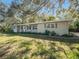Tan single story home with mature landscaping at 1601 Lakeview Rd, Clearwater, FL 33756