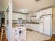 Bright kitchen with white cabinets and granite counters at 1601 Lakeview Rd, Clearwater, FL 33756