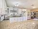 White kitchen cabinets, granite countertops and island at 1601 Lakeview Rd, Clearwater, FL 33756