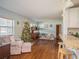 Bright living room features hardwood floors, a Christmas tree, and ample natural light at 1601 Lakeview Rd, Clearwater, FL 33756
