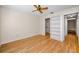 Bright bedroom with hardwood floors, closet, and entry to hallway at 1669 Fry Ct, Dunedin, FL 34698