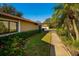 Lush landscaping along the side of the home leads to a detached garage at 1669 Fry Ct, Dunedin, FL 34698