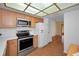 Well-lit kitchen features stainless steel appliances and a unique ceiling light fixture at 1669 Fry Ct, Dunedin, FL 34698