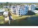 Waterfront condo building with private boat dock and lush landscaping at 3127 W Sligh Ave # 203B, Tampa, FL 33614