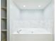 Bathroom with large bathtub and marble tile at 3127 W Sligh Ave # 203B, Tampa, FL 33614
