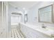 Bathroom with double vanity, marble accents, and a tiled floor at 3127 W Sligh Ave # 203B, Tampa, FL 33614