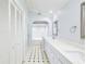 Elegant bathroom with double vanity, marble accents, and a tiled floor at 3127 W Sligh Ave # 203B, Tampa, FL 33614
