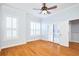 Spacious bedroom with hardwood floors, ceiling fan, and sliding glass doors at 3127 W Sligh Ave # 203B, Tampa, FL 33614