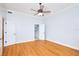 Bedroom with hardwood floors, double doors to bathroom, and ceiling fan at 3127 W Sligh Ave # 203B, Tampa, FL 33614