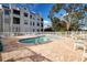 Relaxing community pool with patio furniture and brick pavers at 3127 W Sligh Ave # 203B, Tampa, FL 33614