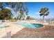 Inviting community pool with lake view and lounge chairs at 3127 W Sligh Ave # 203B, Tampa, FL 33614