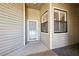 Exterior condo entry with a light gray door and window at 3127 W Sligh Ave # 203B, Tampa, FL 33614