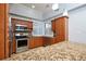 Well-equipped kitchen with granite counters and wood cabinetry at 3127 W Sligh Ave # 203B, Tampa, FL 33614
