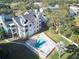Community pool with patio furniture and lake view at 3127 W Sligh Ave # 203B, Tampa, FL 33614