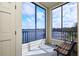Relaxing screened balcony overlooking the lake with bench seating at 3127 W Sligh Ave # 203B, Tampa, FL 33614