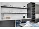 Modern wet bar with floating shelves, wine rack, and beverage cooler at 3402 W Grace St, Tampa, FL 33607