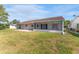Spacious backyard with screened patio and grassy area at 3438 Moog Rd, Holiday, FL 34691