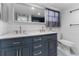 Bathroom with double vanity, updated fixtures and patterned floor at 3438 Moog Rd, Holiday, FL 34691