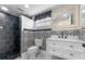 Stylish bathroom with black and white tile, updated vanity and fixtures at 3438 Moog Rd, Holiday, FL 34691