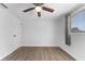 Spacious bedroom with wood-look floors, ceiling fan and window at 3438 Moog Rd, Holiday, FL 34691