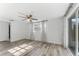 Spacious bedroom with wood-look flooring, ceiling fan, and window coverings at 3438 Moog Rd, Holiday, FL 34691