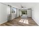 Bedroom with wood-look flooring, ceiling fan and sliding door to patio at 3438 Moog Rd, Holiday, FL 34691