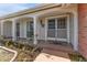 Inviting front porch with brick walkway and landscaping at 3438 Moog Rd, Holiday, FL 34691