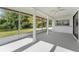 Screened porch with water views and ceiling fan at 3438 Moog Rd, Holiday, FL 34691