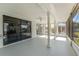 Large screened porch with view of backyard at 3438 Moog Rd, Holiday, FL 34691