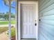 White front door entrance with keyless entry and sidelight at 37525 Moore Dr, Dade City, FL 33525