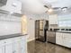 White cabinets, stainless steel appliances, and dark floor at 37525 Moore Dr, Dade City, FL 33525